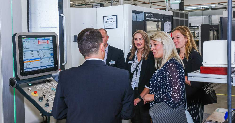 Peter Doyle shows Mayor Tracie Crites a CNC milling cell