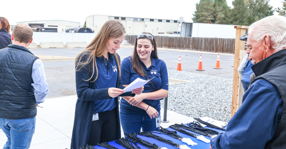 Hirsh employees check guests in for grand opening event