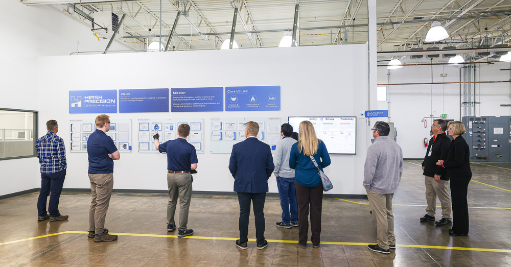 Hirsh employees show guests the company's Vision Wall